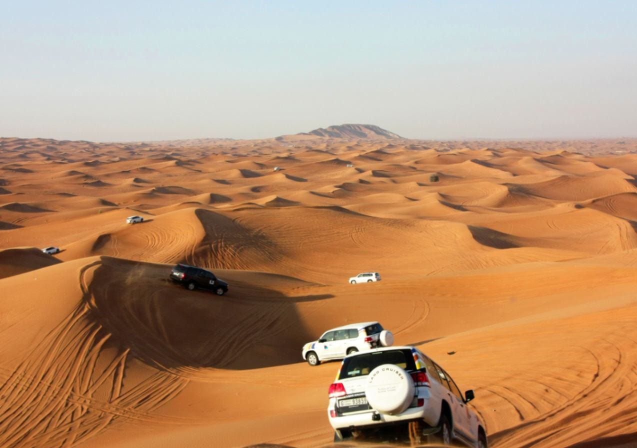 Start your Dubai desert safari trying popular adventure rides like 4×4 dune bashing, ATV quad biking, sandboarding, and camel rides.